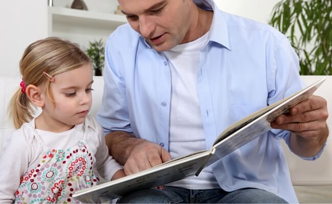 Father reading to his daughter