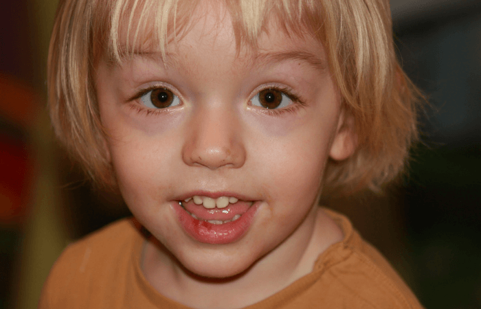 young child smiling at the camera