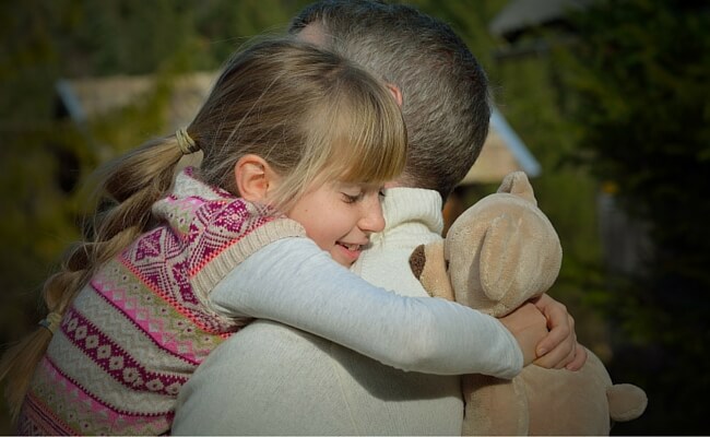 child hugging her dad