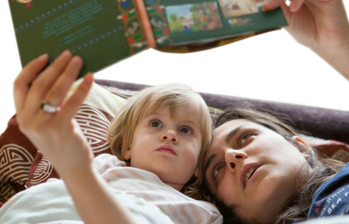 mom reading bedtime story to child