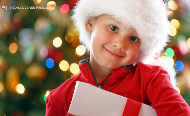 Child with a gift wearing Santa hat