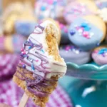close up of finished unicorn rice krispie pop with a bite out of it