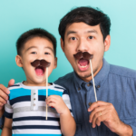 picture of dad and son being silly with chocolate mustaches