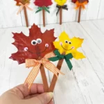 hand holding two leaf puppets