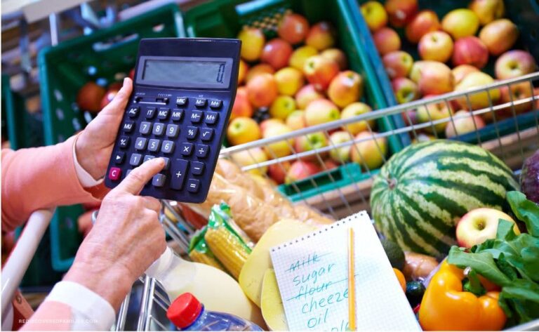 woman with grocery cart- punching numbers into a calculator