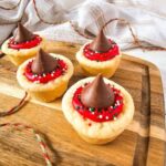 Christmas kiss cookies on a wooden board