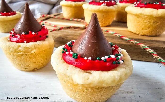 Christmas kiss cookies on a wooden board