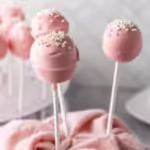 finished cake pops displayed with a pink cloth