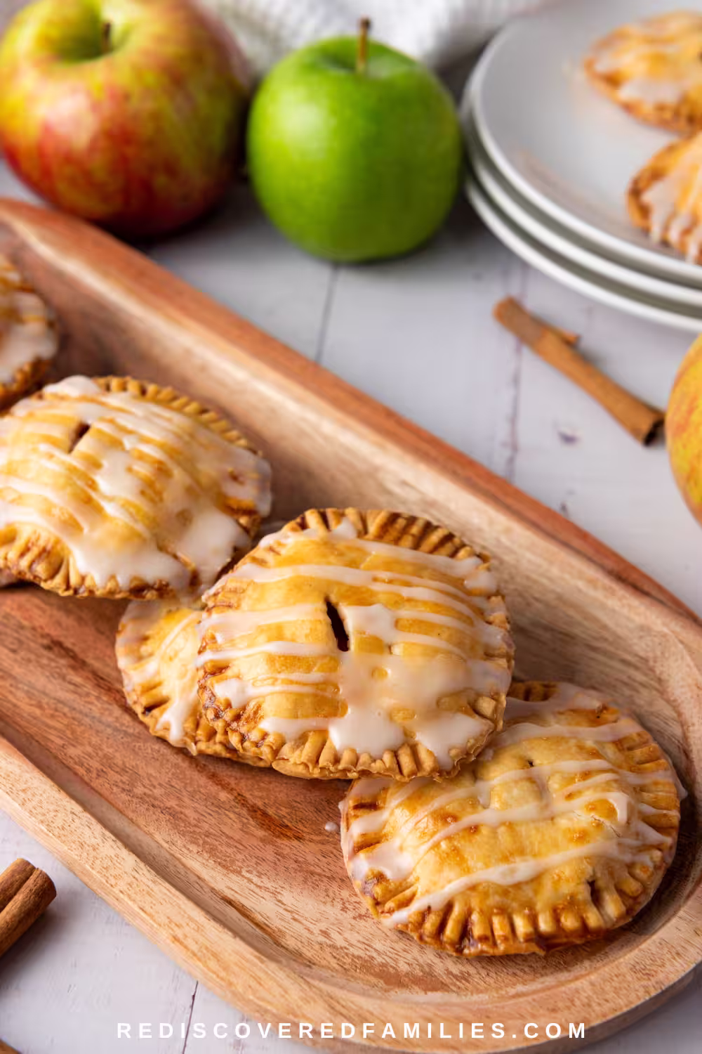 A Pinterest pin showcasing homemade apple hand pies on a board