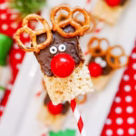 A Reindeer Rice Krispie treat held in front of a tray of similar treats
