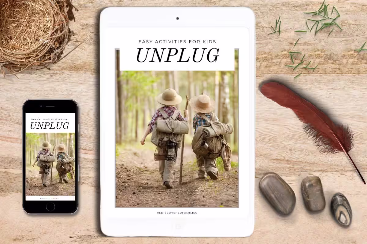 An ebook titled "Unplug: Easy Activities for Kids and Parents" displayed on a tablet and phone surrounded by nature items