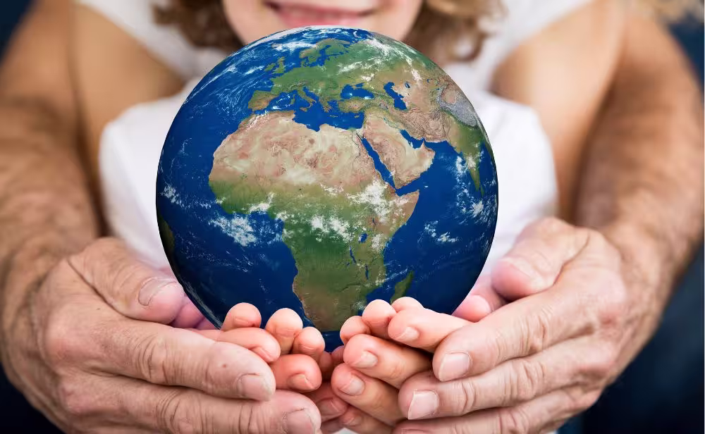 parent and child holding a globe in their hands