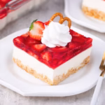 A square of strawberry pretzel salad on a white plate