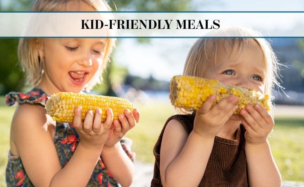 two children eating corn- text overlay reads,"Kid friendly Meals."